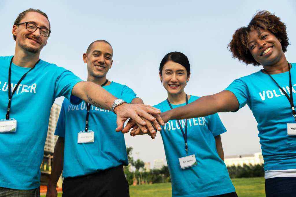 4-volunteers-joining-hands-to-help-society