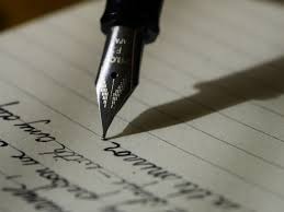 photo depicts writing with a pen