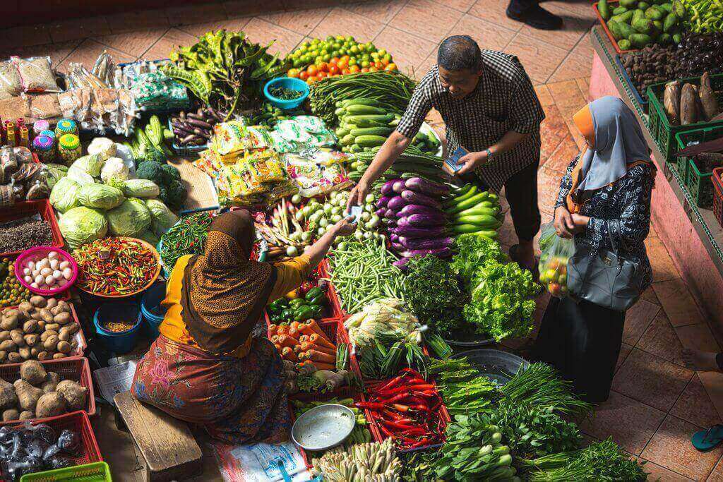 Couples are buying vegetables in consumer market
