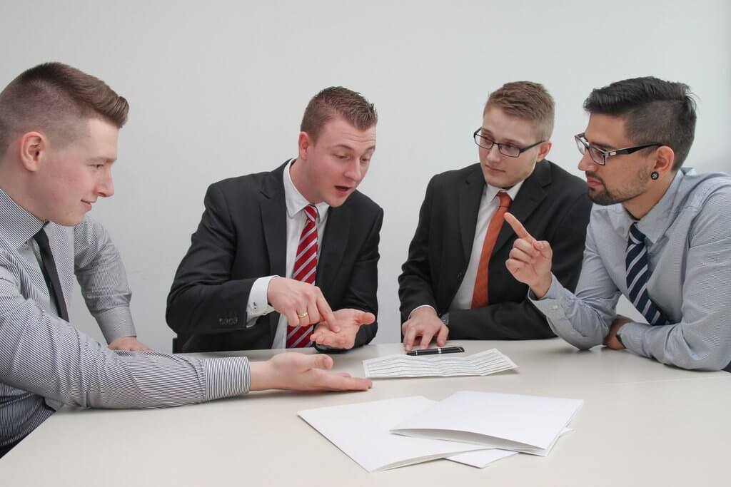 The buying team of a Business Market discuss their plan.