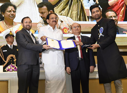 The Vice President, Shri M. Venkaiah Naidu presenting the Rajat Kamal Award to the Actor: Shri Vicky Kaushal for Best Actor: URI: The Surgical Strike, at the 66th National Film Awards function, in New Delhi on December 23, 2019. 	The Union Minister for Environment, Forest & Climate Change, Information & Broadcasting and Heavy Industries and Public Enterprise, Shri Prakash Javadekar and the Secretary, Ministry of Information & Broadcasting, Shri Ravi Mittal are also seen.