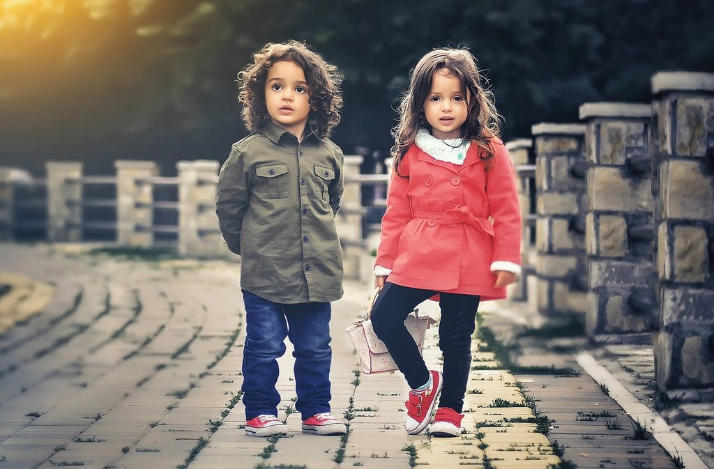 Two kids wearing garments or dress