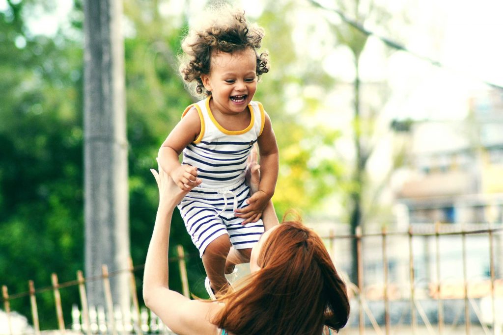 happy kid playing with mother