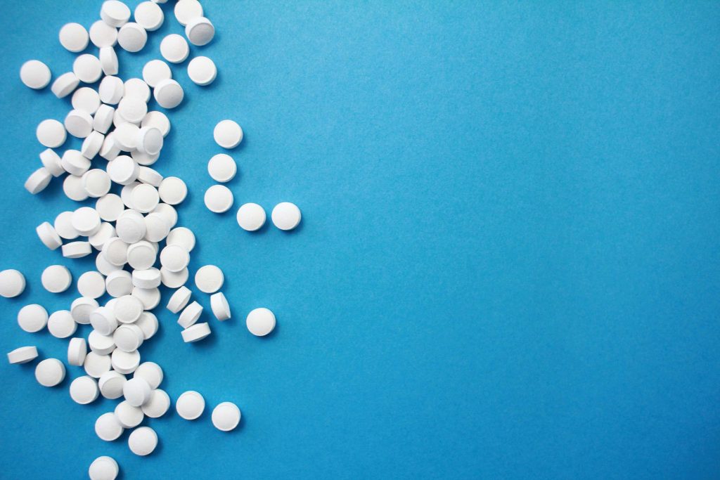 medicines white pills on blue table