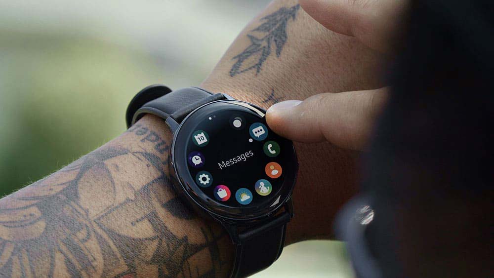 a man wearing Samsung galaxy watch active 2 smartwatch