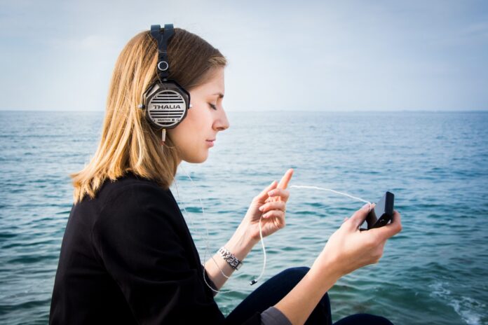 a woman listening to music with best headphones